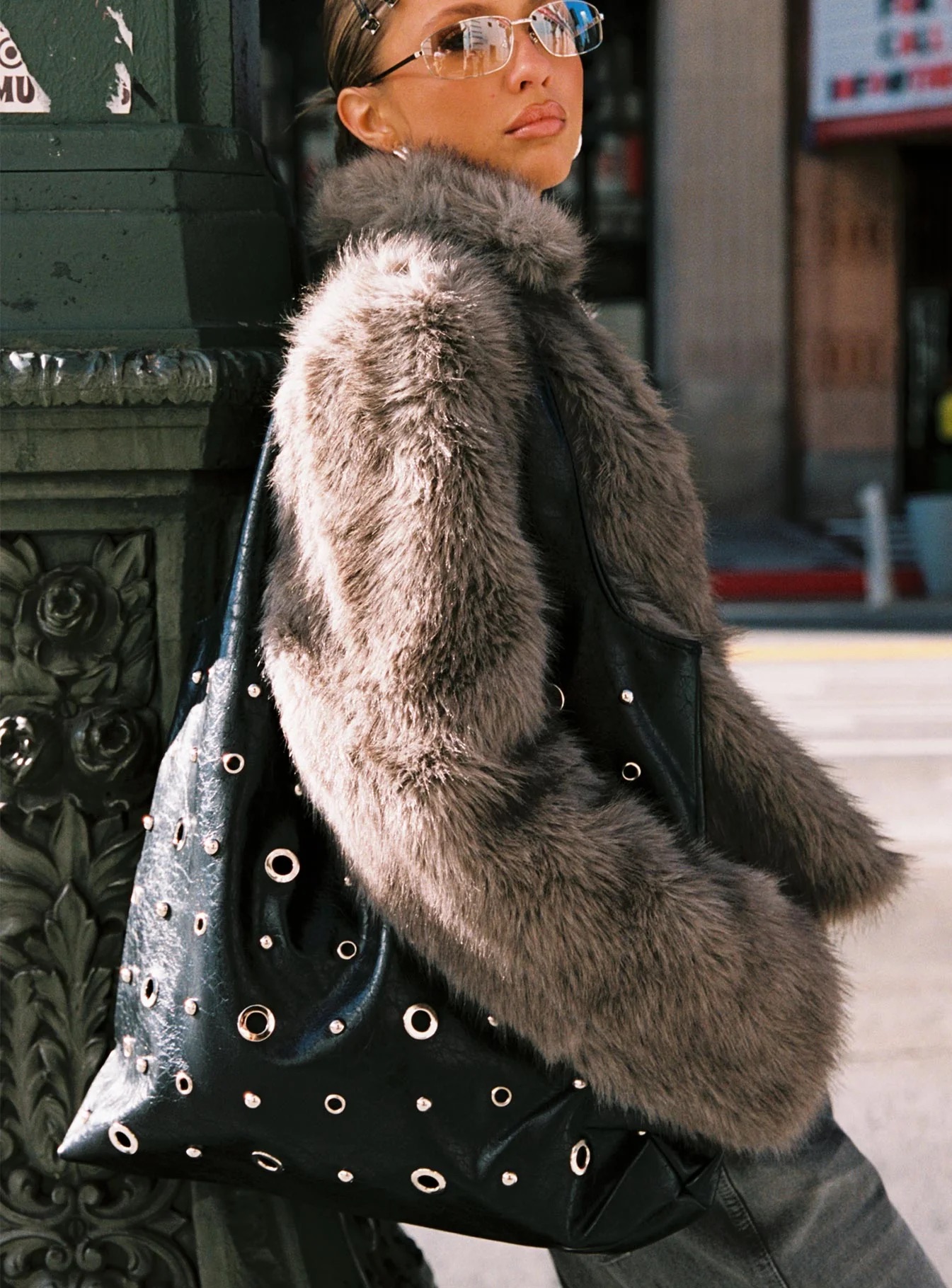 woman wearing eyelet detail shoulder bag for winter date night