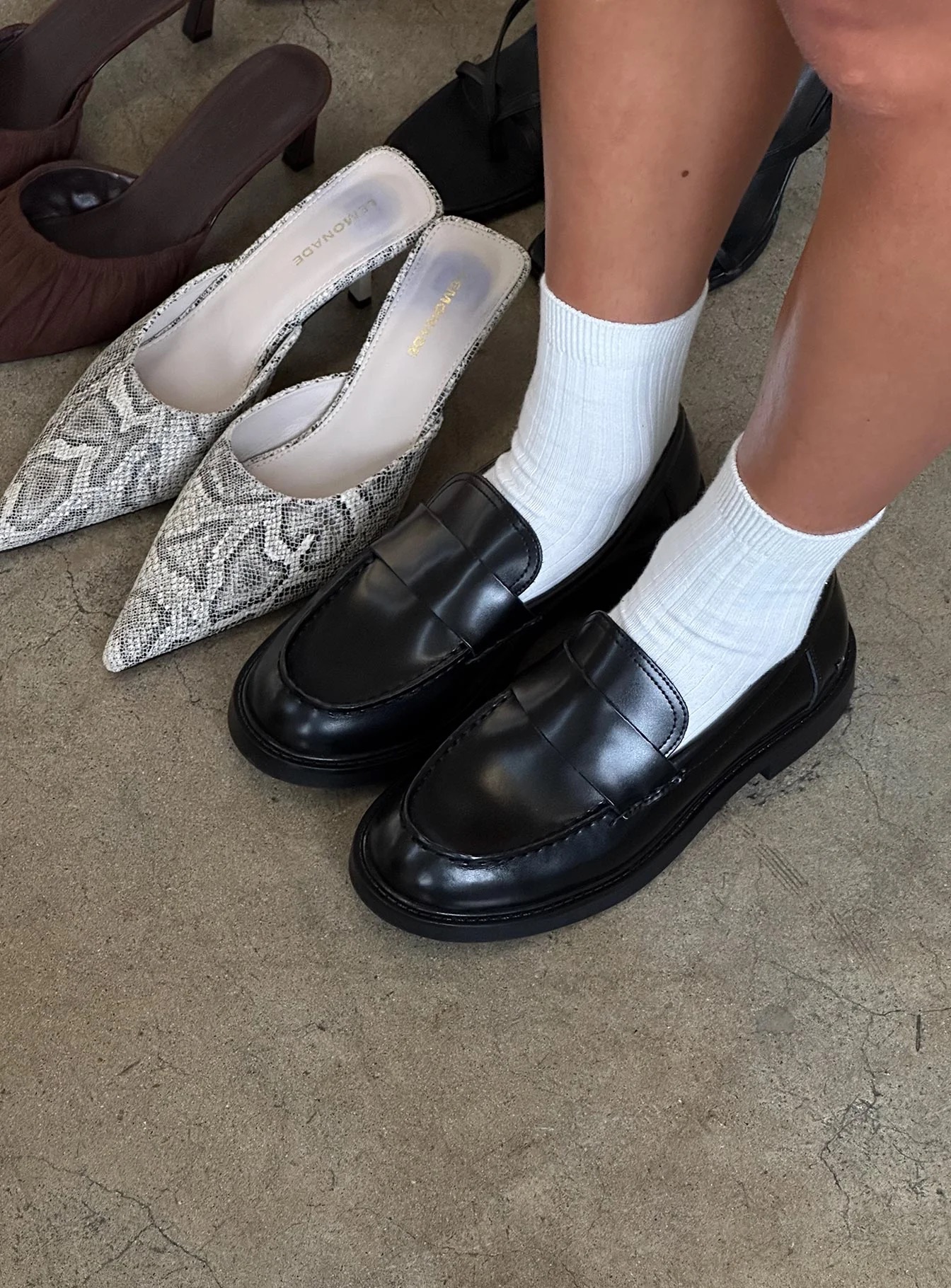 woman wearing black loafers for winter date night