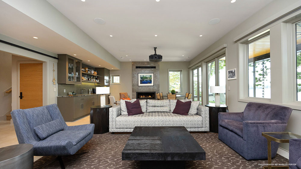 Media room with a projector mounted on the ceiling in lakehouse