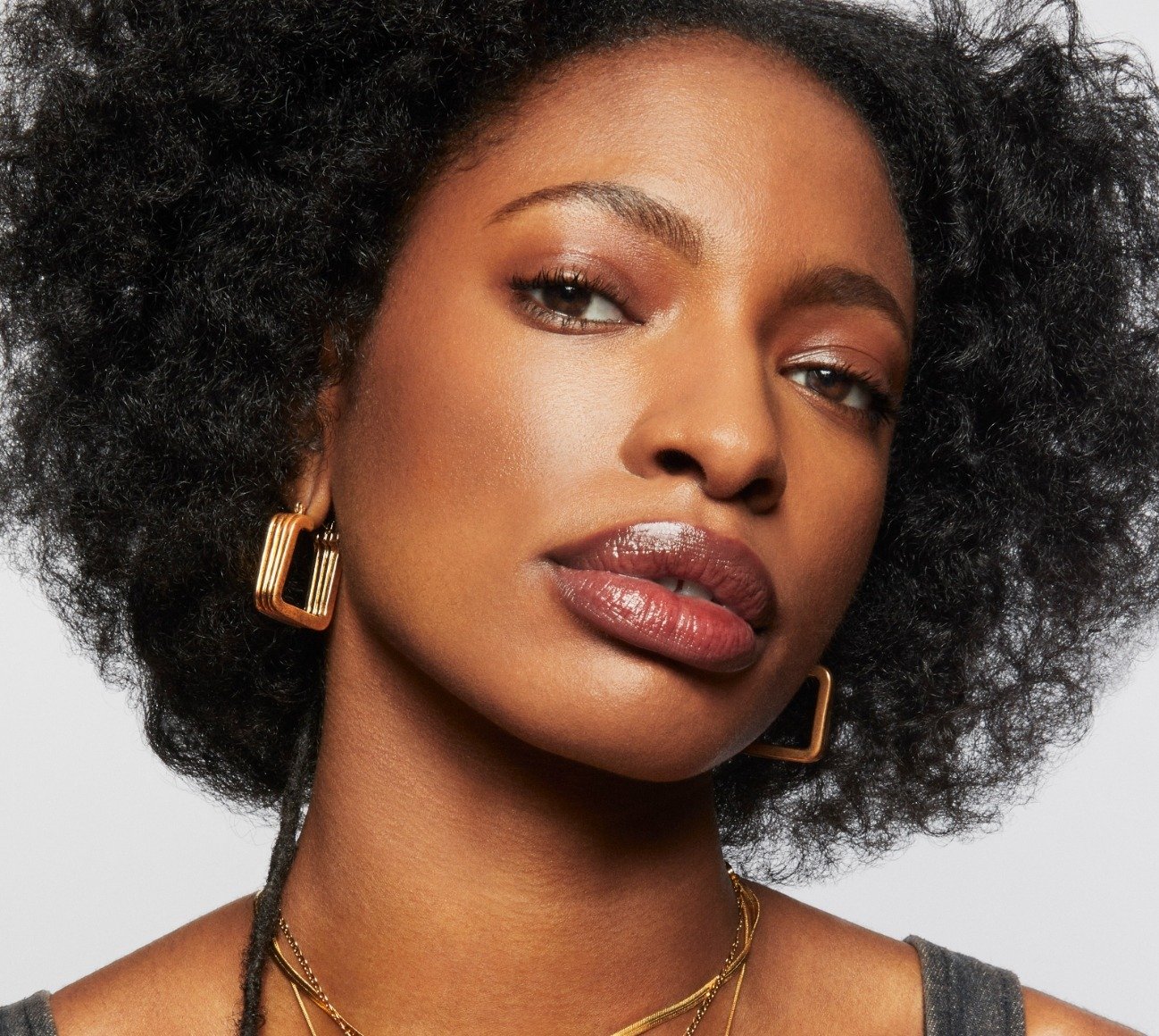 Model wears a full face of Milk Makeup Including Bionic Glow against a light gray background