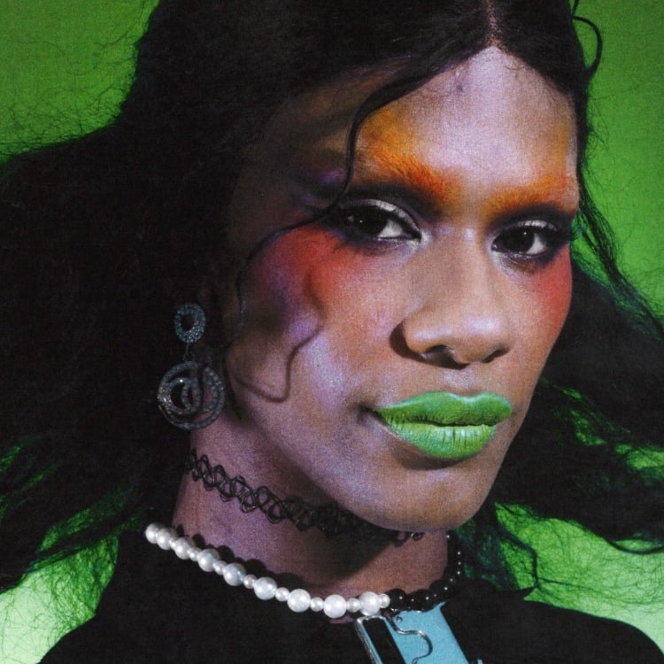 Close-up portrait of Haus of Telfar member Iris on green background