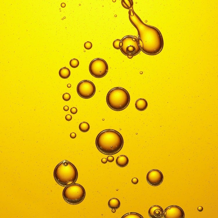 Close-up shot of yellow-tinted oil