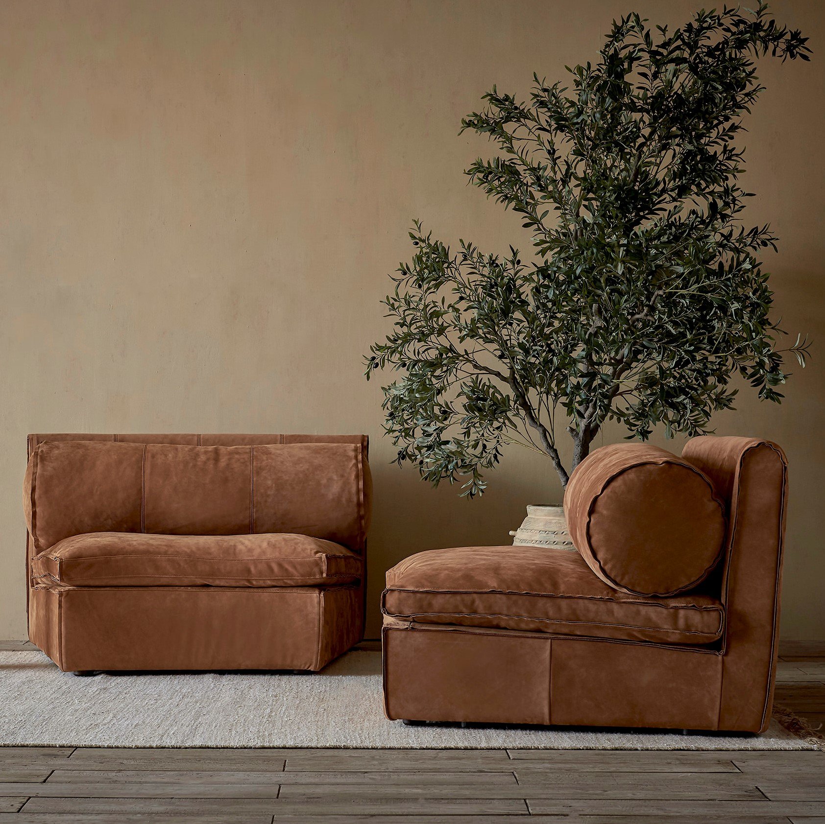 Two Camino Leather Chairs in Sunset Canyon, Meridian Leather, placed in a room on top of a rug