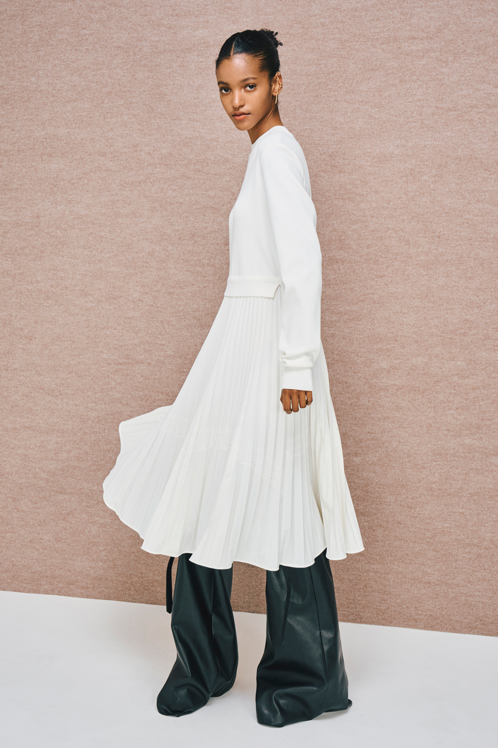 Model is wearing a white dress.