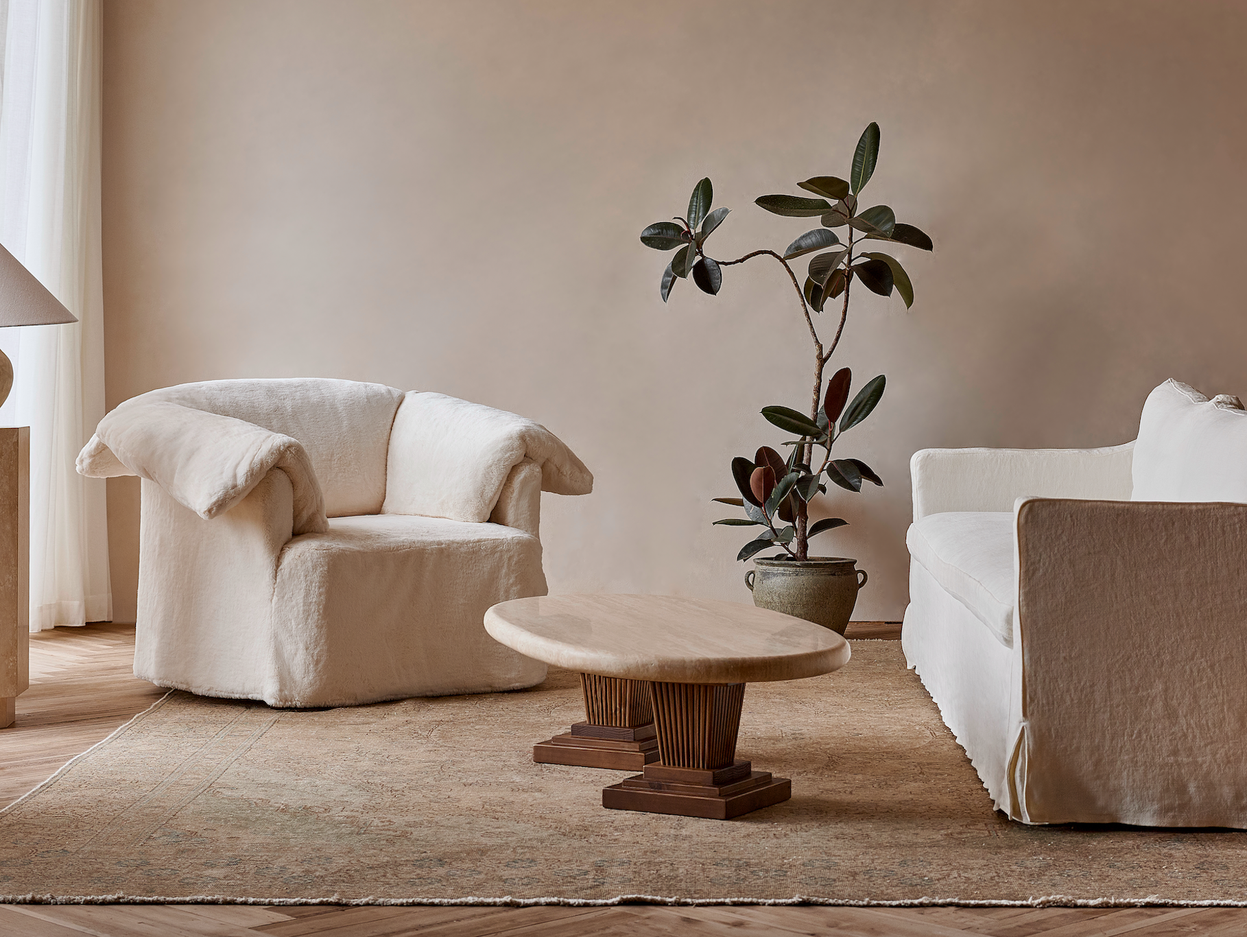 Cordelia Coffee Table placed in the center of a room beside the Loula Chair in Recycled Faux Fur Dandelion Poof and Gabriel Sofa Washed Cotton Linen Corn Silk