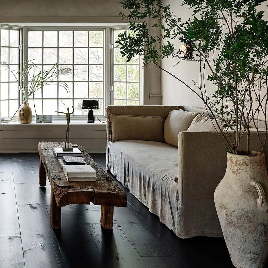 Monk Sofa placed by a windowsill next to a coffee table