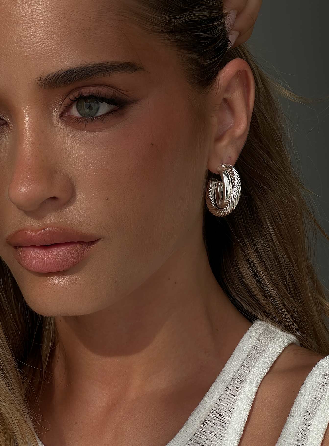 woman wearing princess polly silver hoops to graduation ceremony