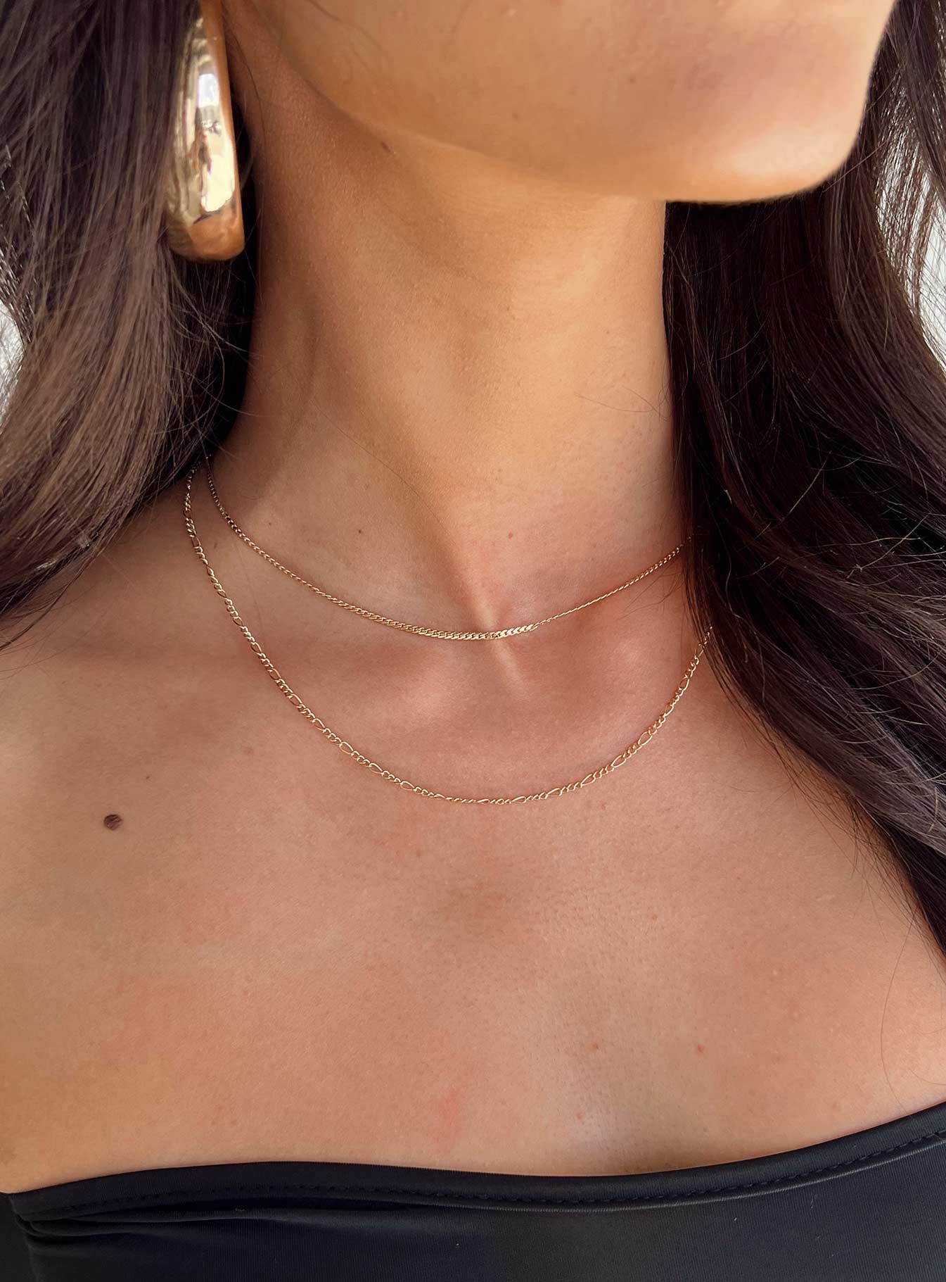 woman wearing princess polly gold necklace to graduation ceremony