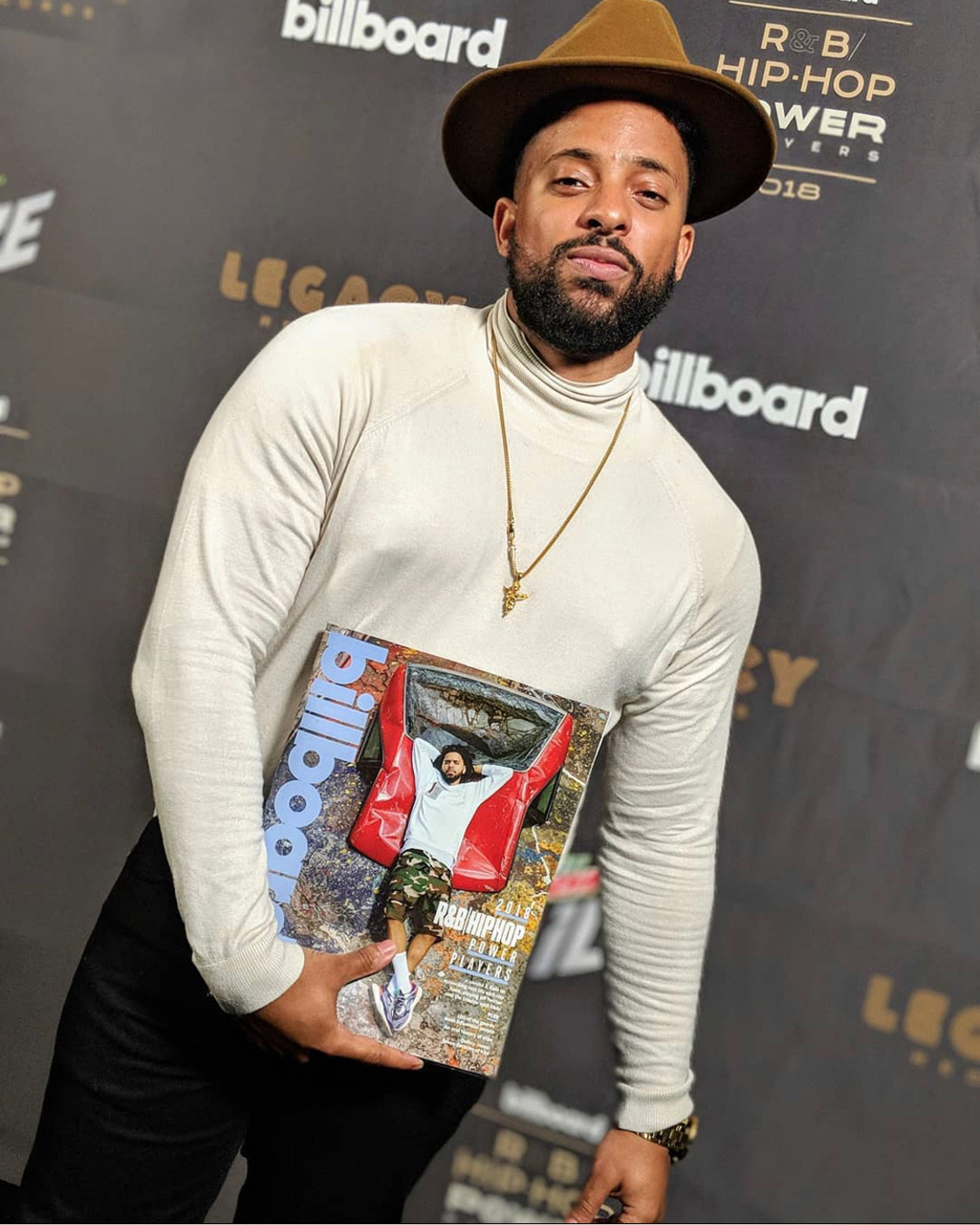Carl Lamarre holding Billboard’s 2018 R&B/Hip-Hop 100 Power Players issue