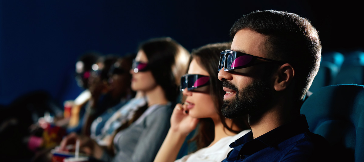People watching a movie with 3D glasses.