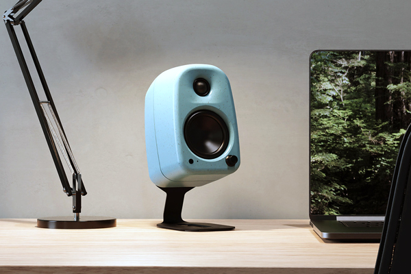 Kanto UKI desktop speaker in cornflower blue on a stand