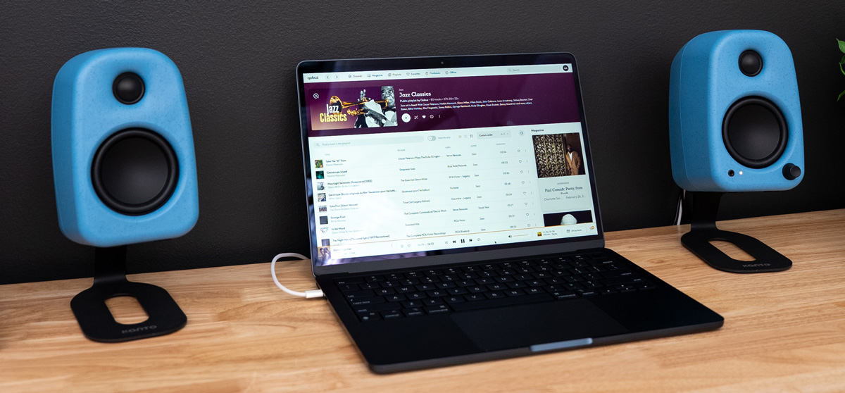 Kanto UKI in cornflower on Kanto SU2 stands on either side of a laptop