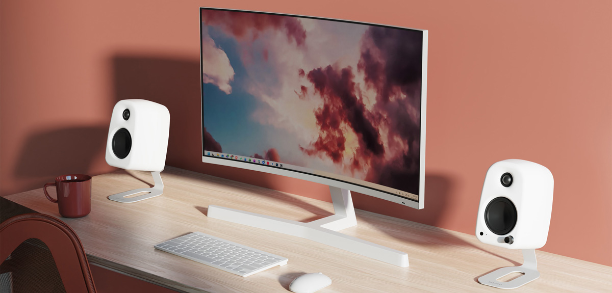 Kanto UKI desktop speakers in white on computer desk