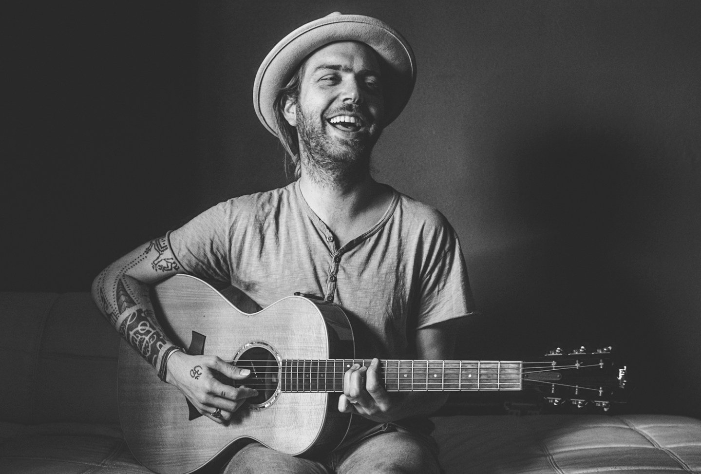 Black and white photograph of Trevor Hall playing a guitar