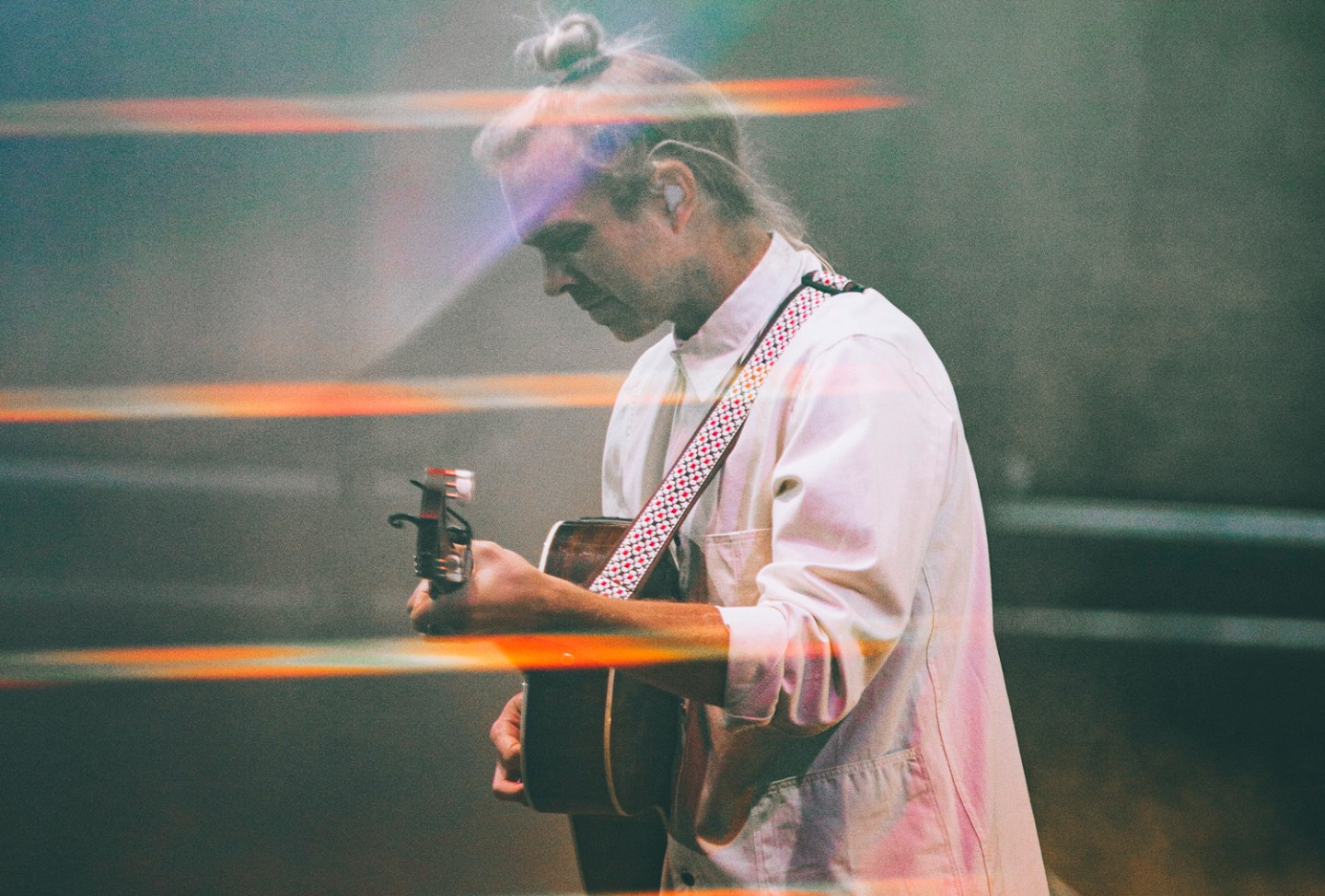 Black and white photograph of Trevor Hall playing a guitar