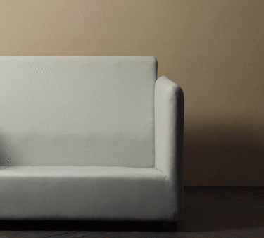 animated image of a person putting a slipcover on a Neva Chair frame