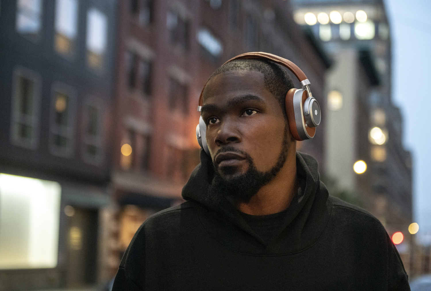 On the street wearing MW65 Active Noise-Cancelling Wireless Headphones