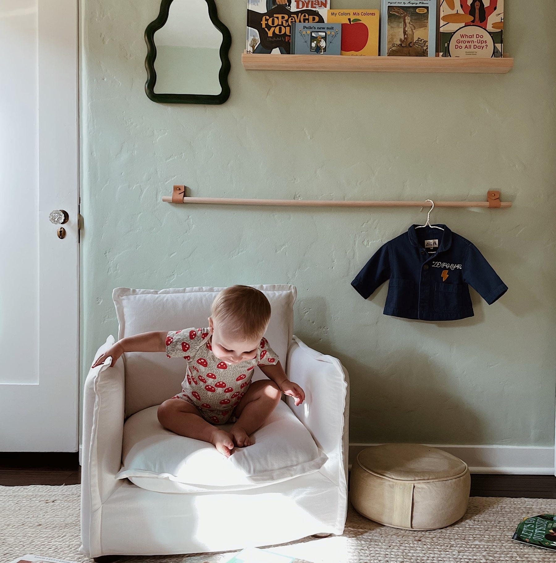A baby sitting on the Little Neva Chair in Pacific Pearl, Cotton Linen