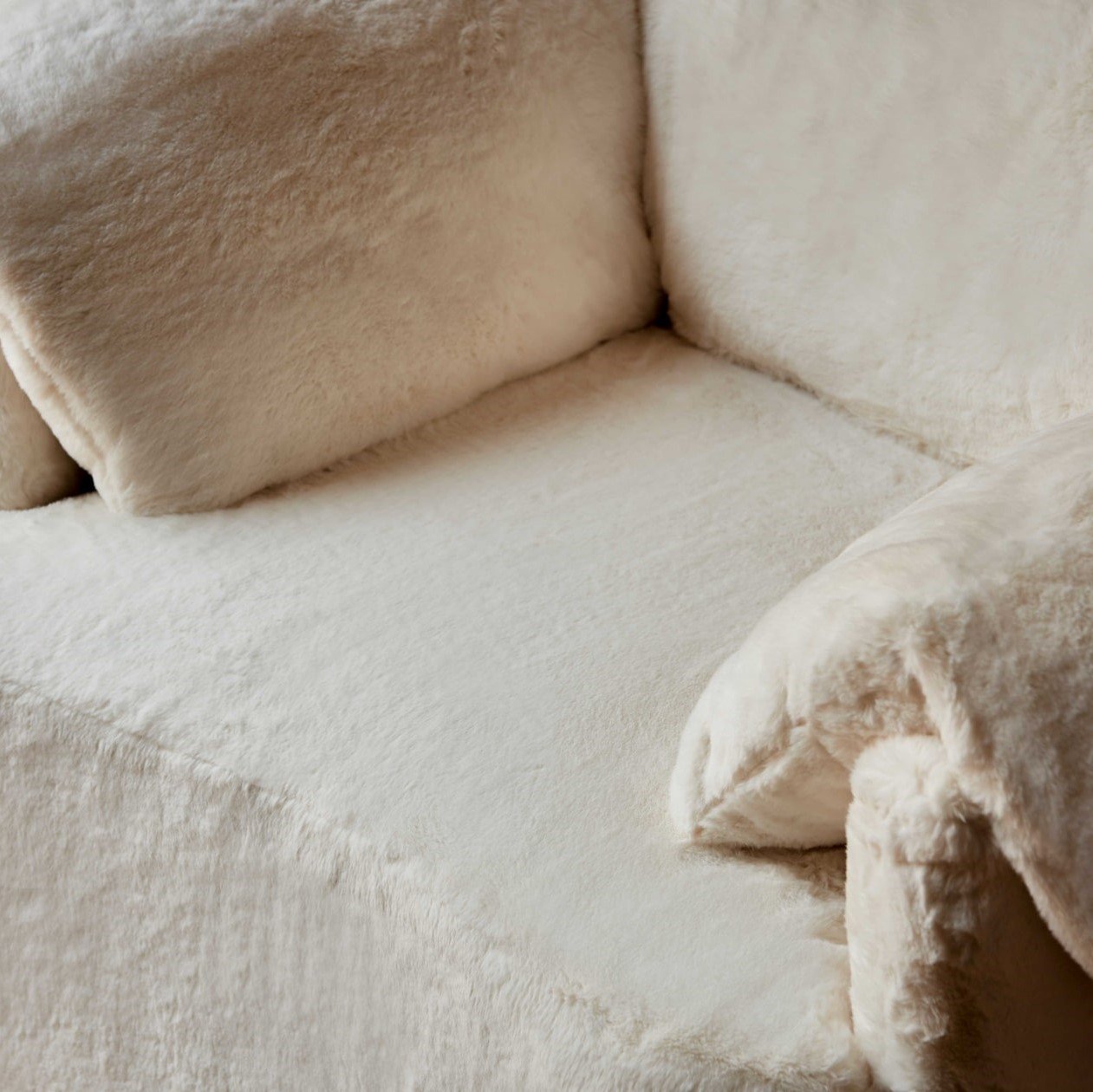 close up view of Loula Chair in Dandelion Poof, Recycled Faux Fur