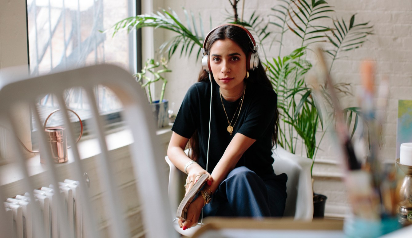 Photograph of painter, photographer, and videographer Bianca Valle wearing Master and Dynamic headphones