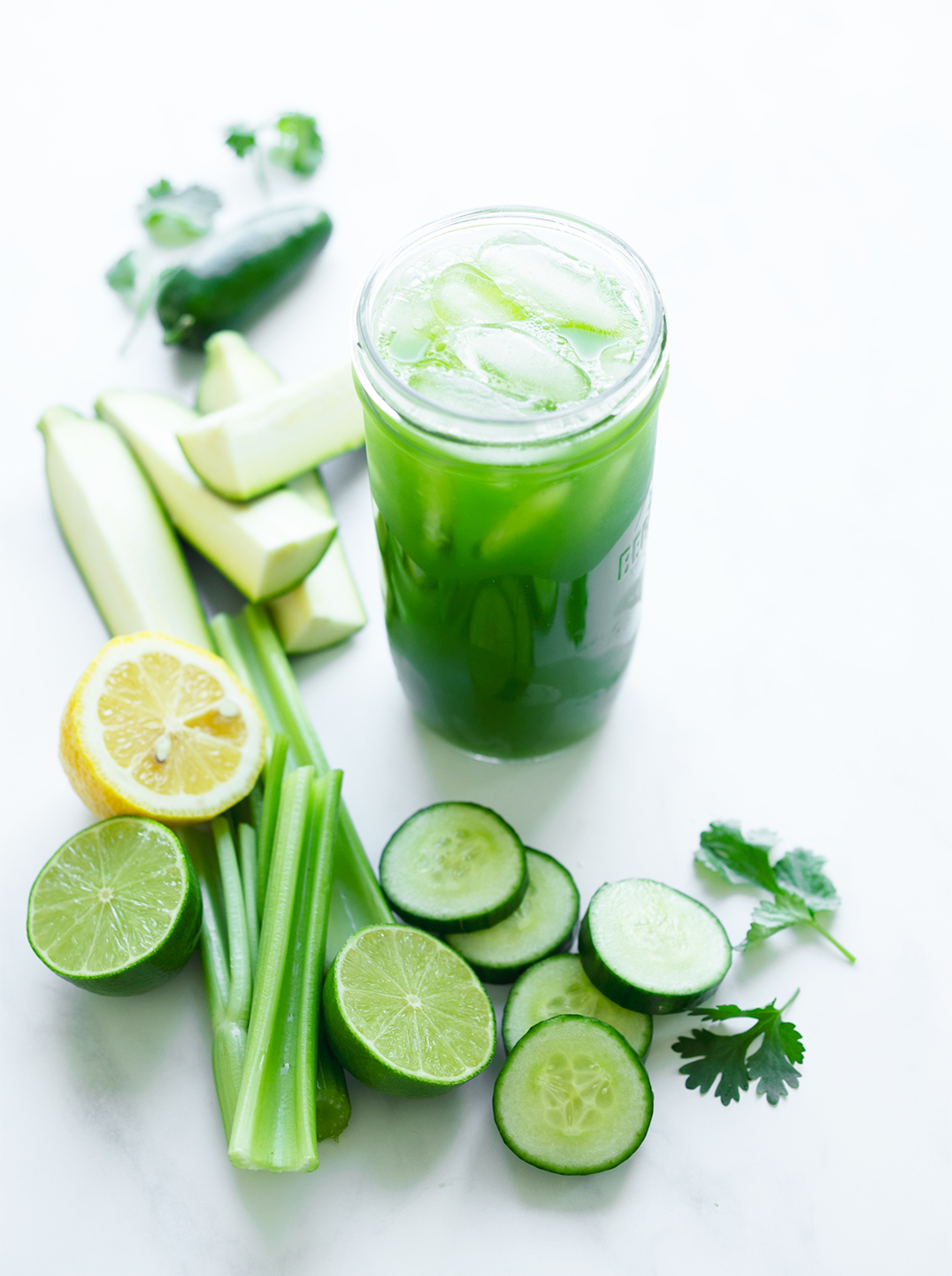 Glass of iced Lean Green Juice and recipe ingredients