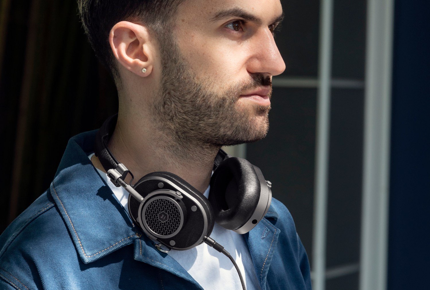 Lifestyle image of DJ A-Trak wearing Master and Dynamic headphones