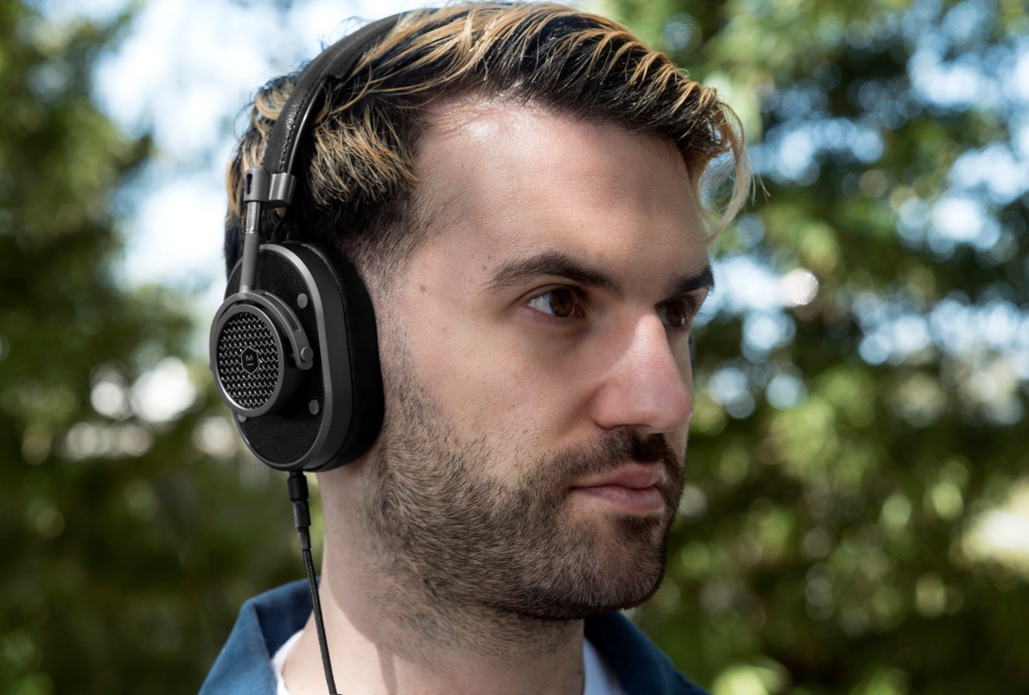 Lifestyle image of DJ A-Trak wearing Master and Dynamic headphones
