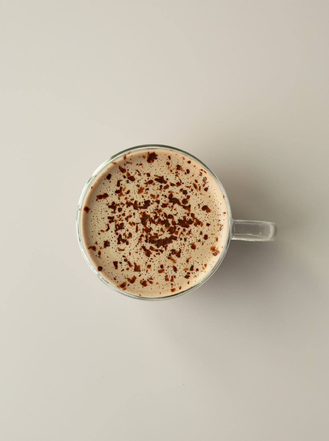 a glass mug filled with hazelnut maca hot. chocolate