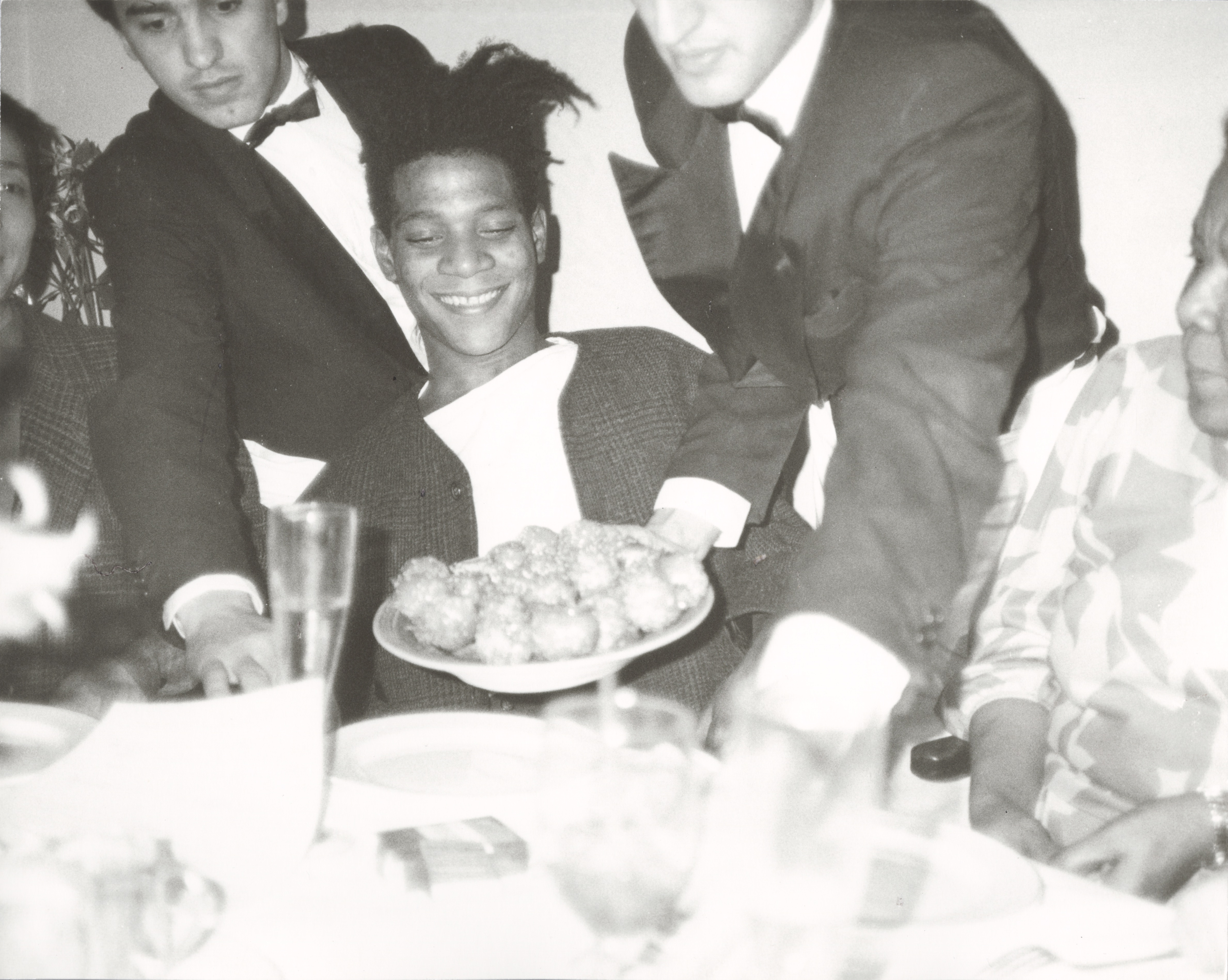Jean-Michel Basquiat Dinner at Mr. Chow, 1985 unique gelatin silver print © The Andy Warhol Foundation for the Visual Arts, Inc. Licensed by Artists Rights Society (ARS), New York.