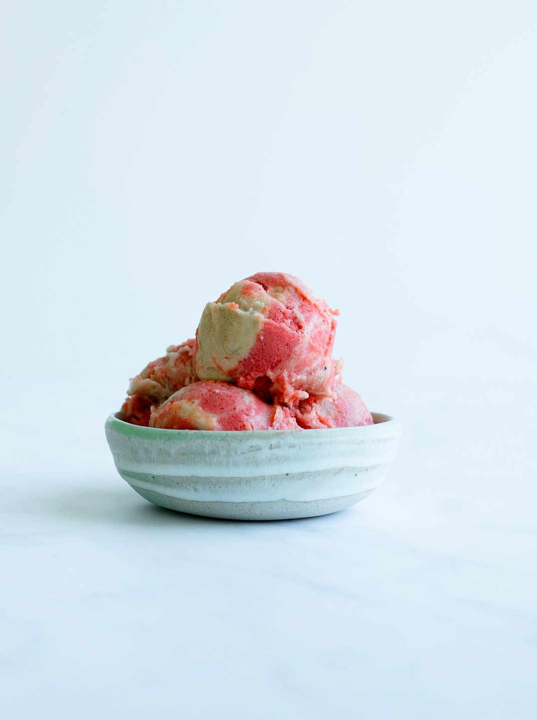 a bowl with 3 scoops of Creamy Banana Rhubarb Sorbet
