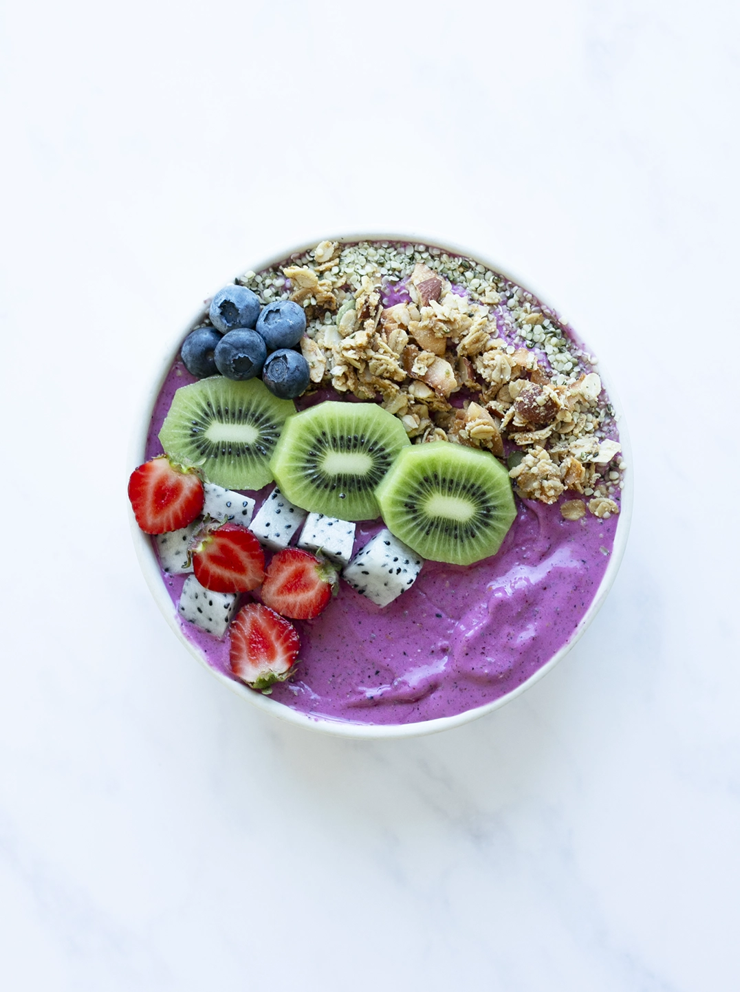 plant power bowl topped with berries kiwi granola and seeds