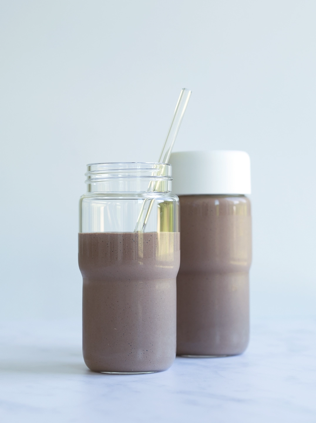 two Nama glass bottles filled with chocolate pudding shake
