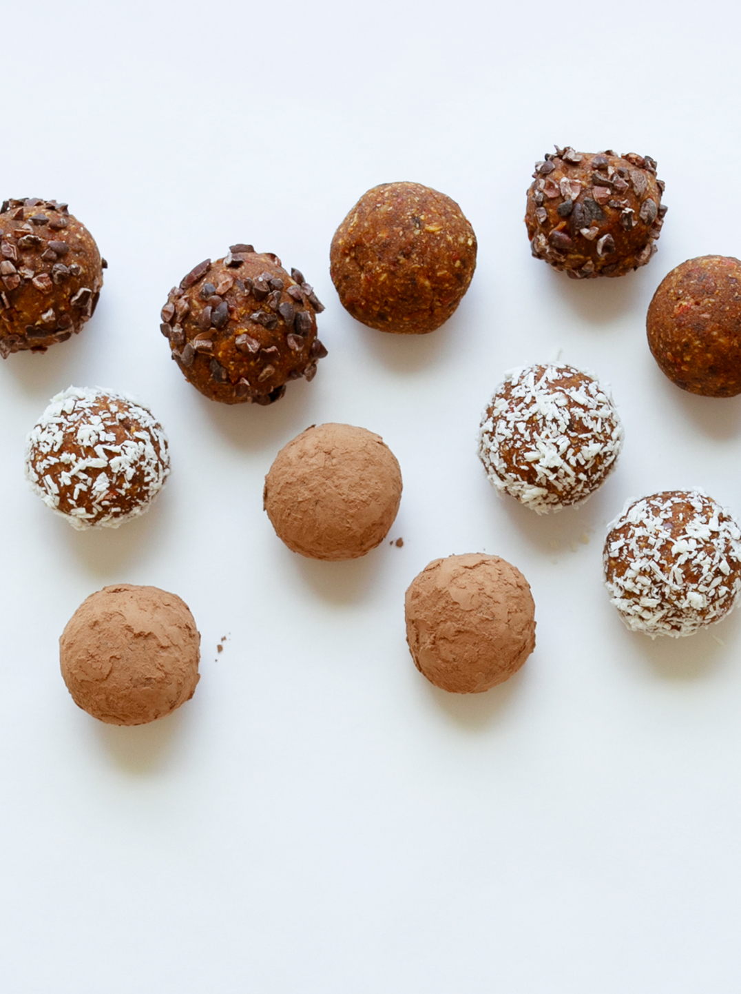10 raw energy bites on a white surface 