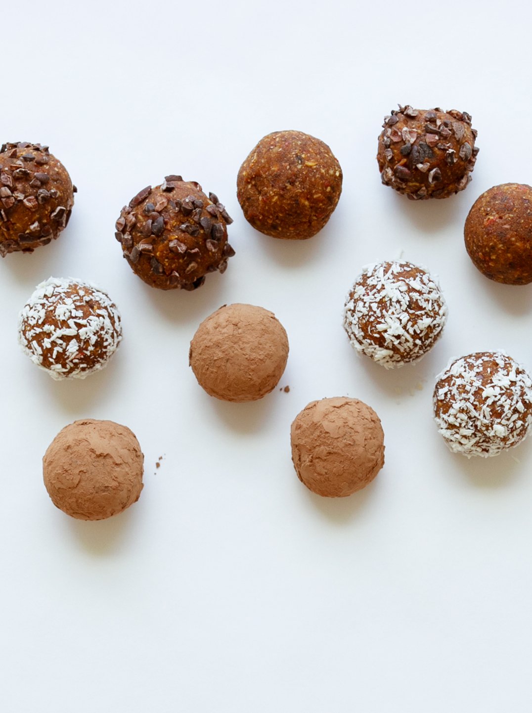 10 raw energy bites on a white surface