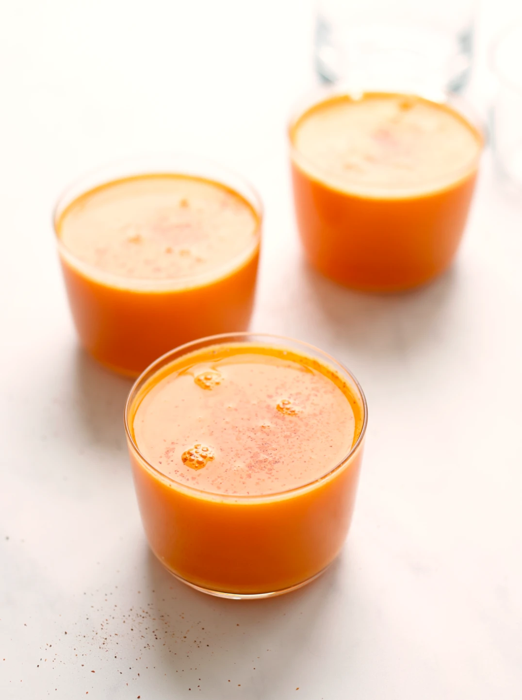 3 glasses of bright orange golden root immunity juice