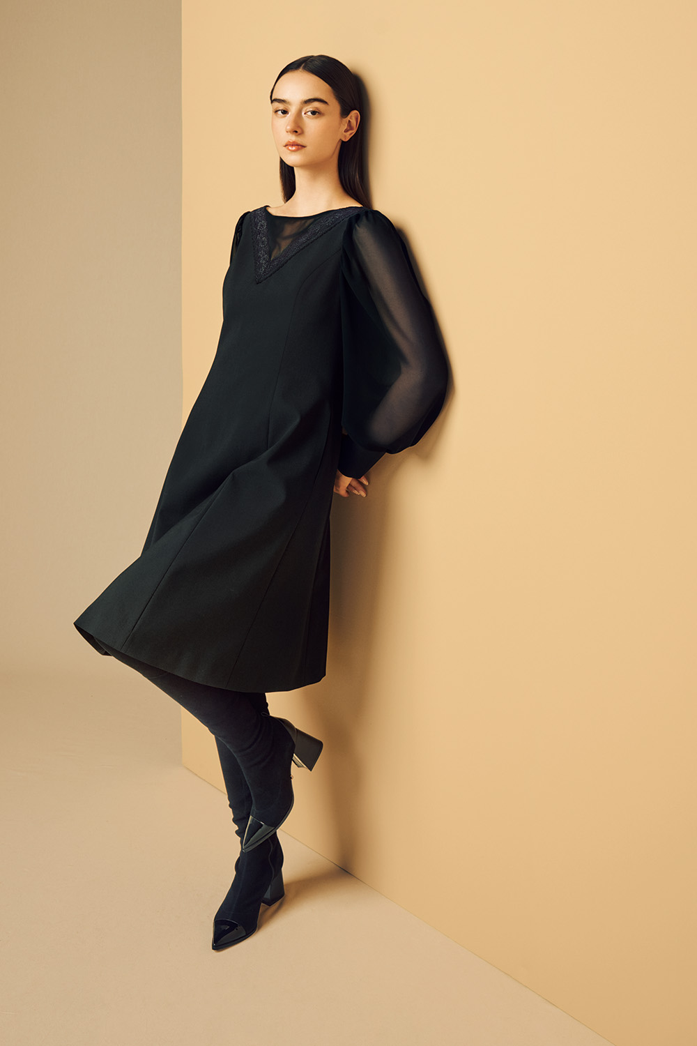 Model is wearing a black dress.