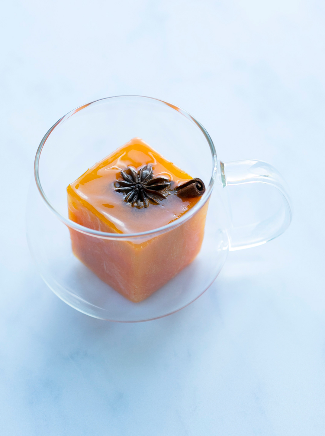 A glass teacup with a winter immunity cube