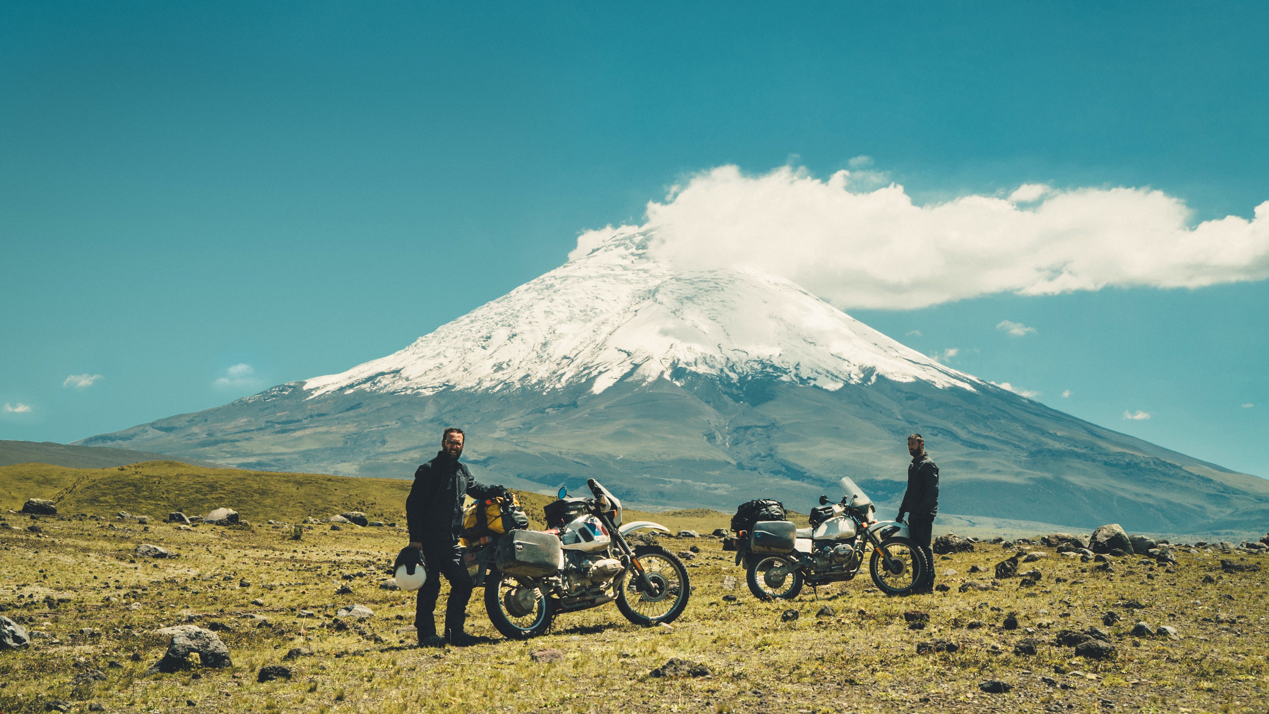 Corea and his bikes in front of Cotopaxi, a stratovolcano in the Andes Mountains, in Ecuador.