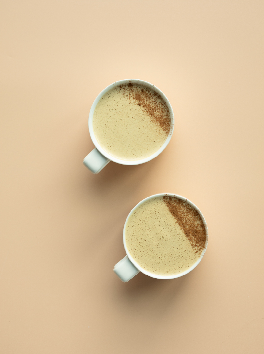 Overhead shot of two mugs with gingerbread latte