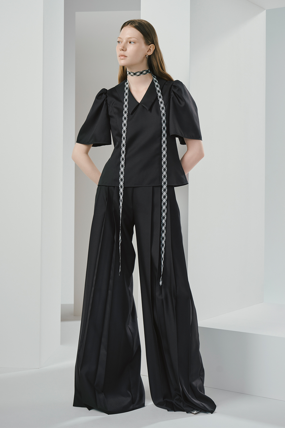 Model is wearing a black top and pants.