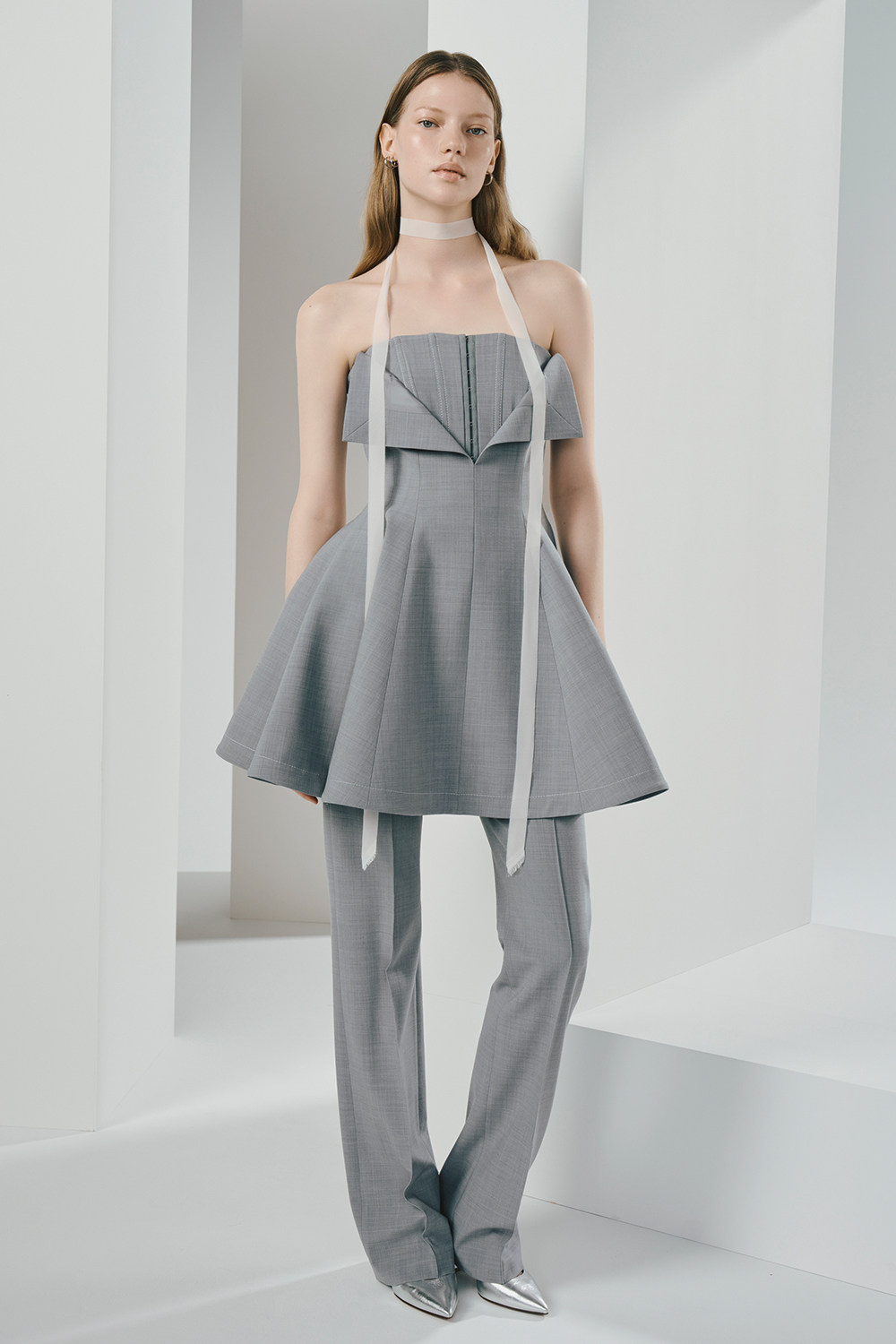 Model is wearing a gray top and pants.