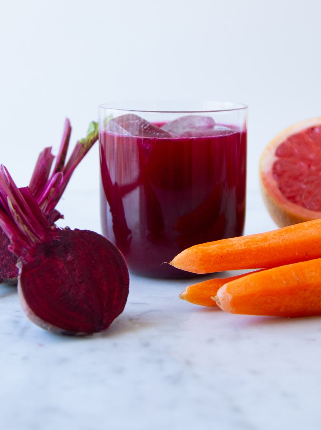 a glass of root remedy juice with half a beet