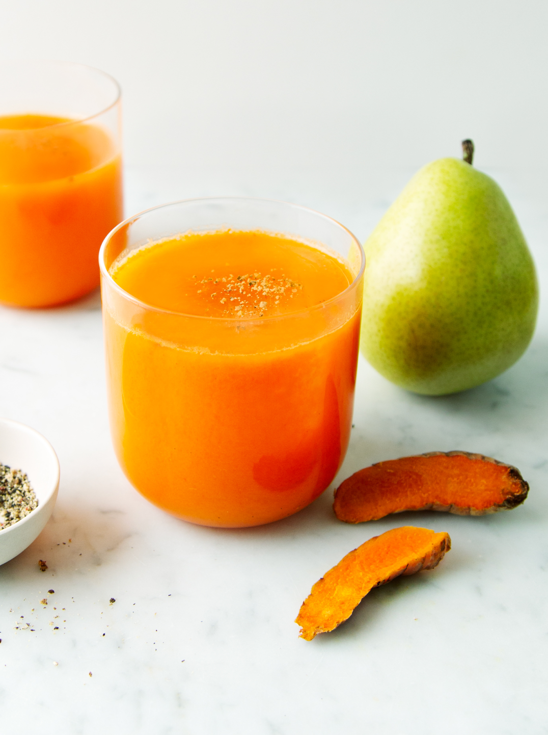 2 glasses of golden warmth juice and a pear
