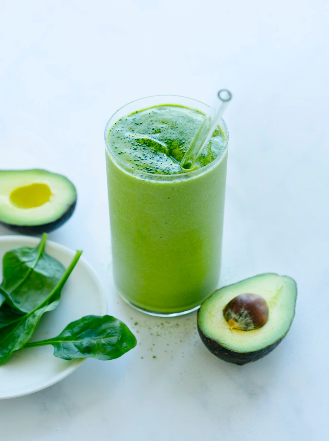 a glass of plant power smoothie with avocado and spinach/