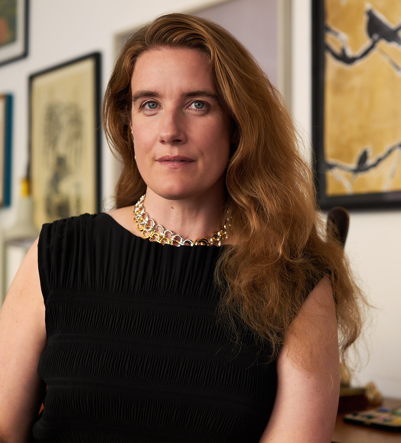 Portrait of Alice Cicolini. She has sandy brown hair that goes past her shoulders. She is wearing a gold chain necklace and a black sleeveless top. She is light eyed and fair skinned.