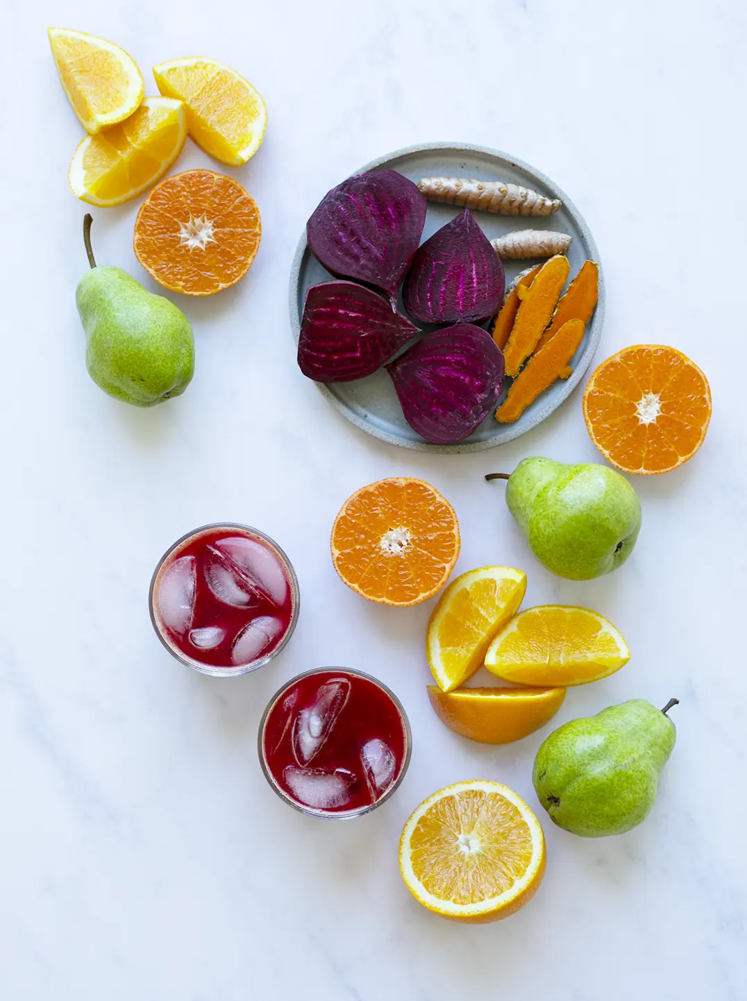 2 glasses of red sunrise juice with ingredients