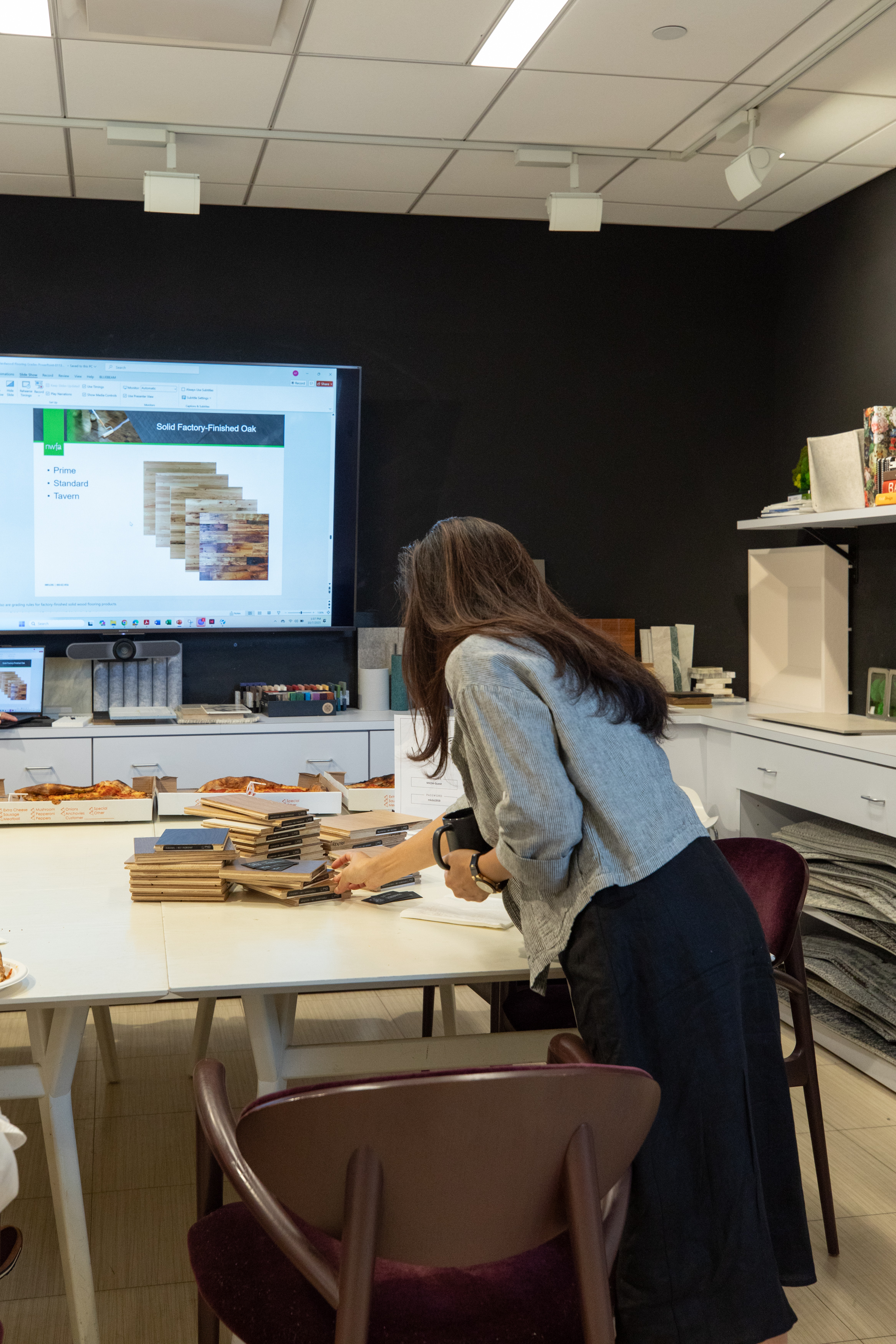 Designers examining hardwood flooring options during MKDA collaboration