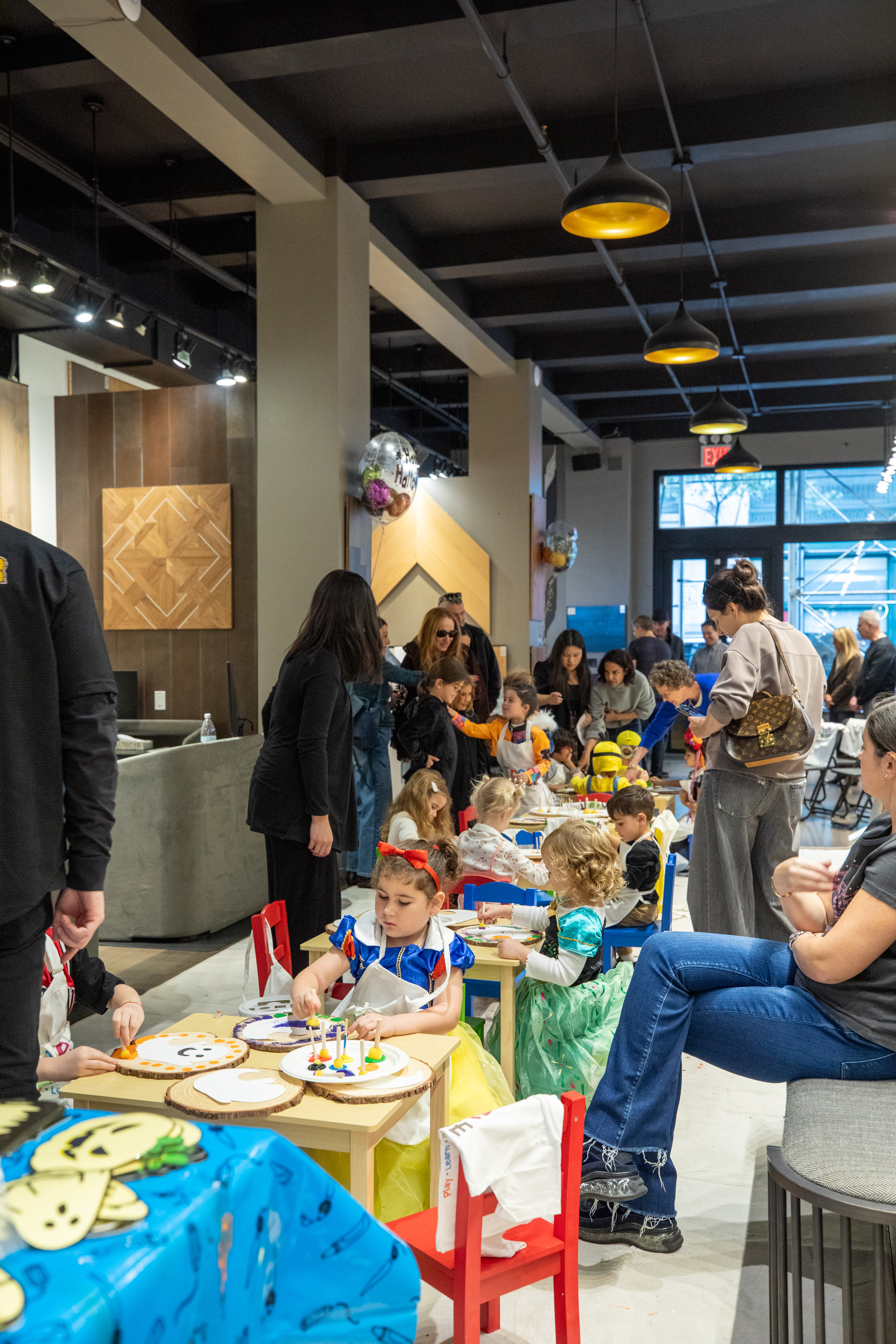 Costumed guests mingling at PID Floors Halloween 2025 celebration