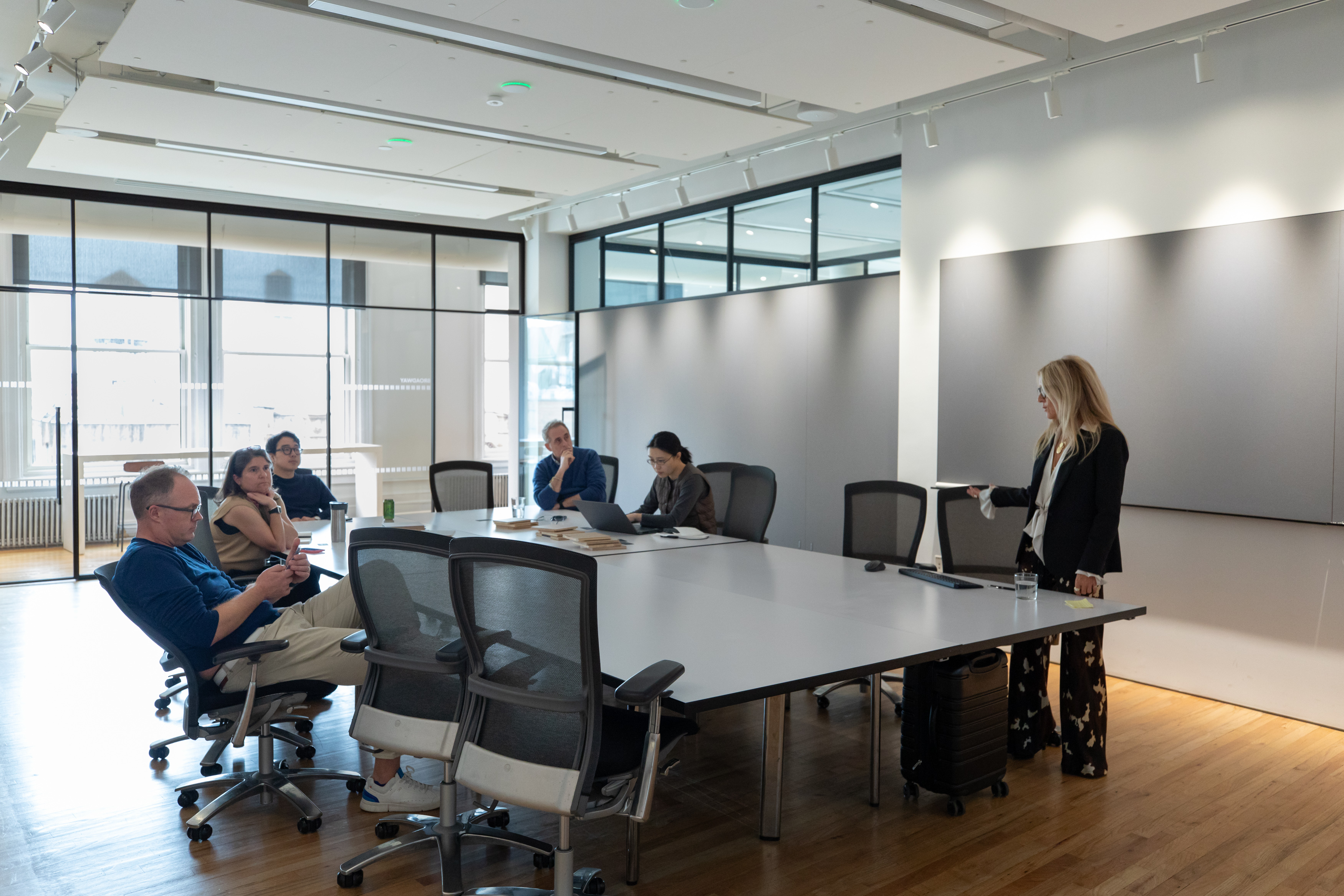 Group conversation about sustainable flooring innovations at PID Floors