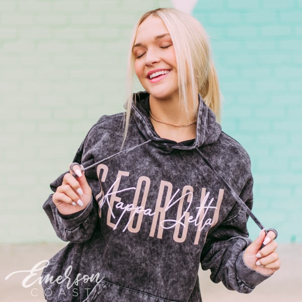 girl wearing a pi phi ash gray sweatshirt